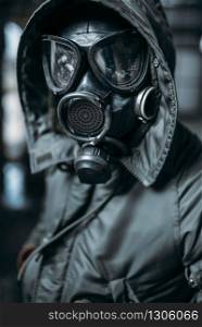 Stalker concept, male person in gas mask, radiation danger. Post apocalyptic lifestyle, doomsday, horror of nuclear war. Stalker in gas mask, radiation danger