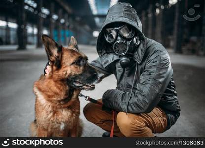 Stalker in gas mask and dog in abandoned building, survivors in danger zone after nuclear war. Post apocalyptic world. Post-apocalypse lifestyle on ruins, doomsday, judgment day. Stalker and dog, survivors in danger zone