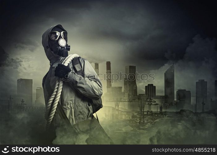 Stalker in gas mask. Man in gas mask against disaster background. Pollution concept