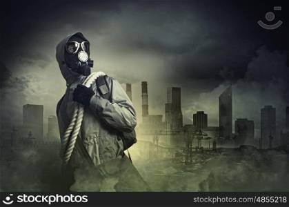 Stalker in gas mask. Man in gas mask against disaster background. Pollution concept