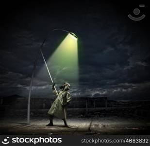 Stalker in gas mask. Man in gas mask and camouflage standing under street light