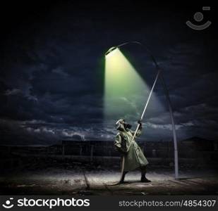 Stalker in gas mask. Man in gas mask and camouflage standing under street light