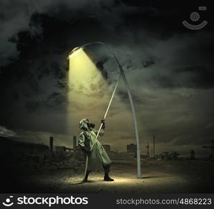 Stalker in gas mask. Man in gas mask and camouflage standing under street light