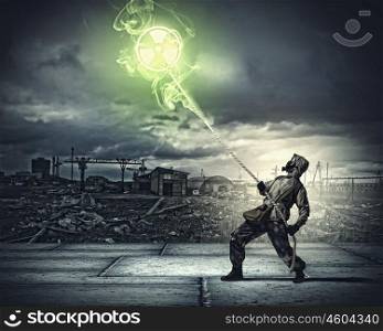 Stalker in gas mask. Man in respirator against nuclear background. Radioactivity concept