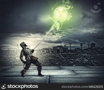Stalker in gas mask. Man in respirator against nuclear background. Radioactivity concept