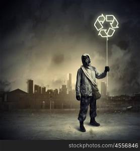 Stalker in gas mask. Man in respirator against nuclear background. Recycle concept