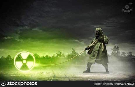 Stalker pulling rope. Man in respirator against nuclear background. Radioactivity concept