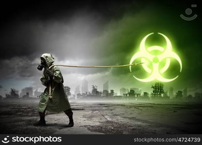 Stalker pulling rope. Man in respirator against nuclear background. Radioactivity concept