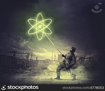 Stalker pulling rope. Man in respirator against nuclear background. Radioactivity concept