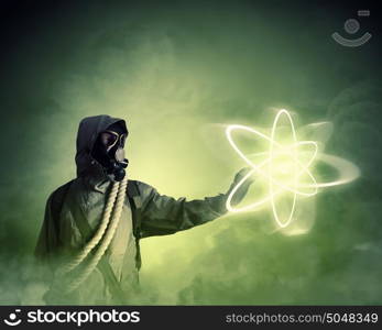 Stalker touching sign. Image of man in gas mask and protective uniform touching atom sign