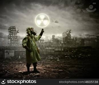 Stalker touching sign. Image of man in gas mask and protective uniform touching radioactivity sign