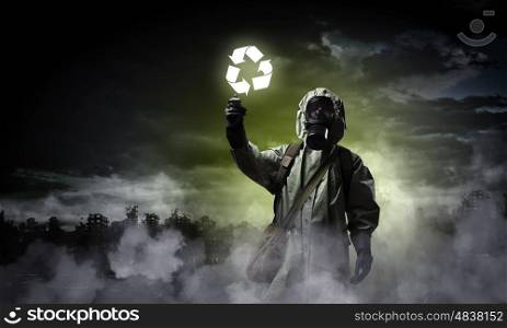 Stalker touching sign. Image of man in gas mask and protective uniform touching recycle sign