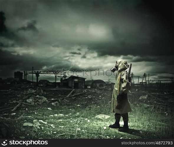 Stalker with gun. Man in gas mask and camouflage holding gun. Disaster concept