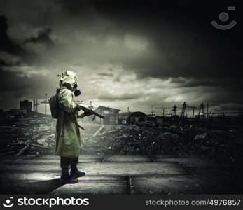 Stalker with gun. Man in gas mask and camouflage holding gun. Disaster concept