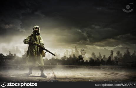 Stalker with gun. Man in gas mask and camouflage holding gun. Disaster concept