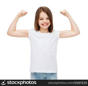 stamina, strength, health, sport, fitness concept - smiling teenage girl in blank white t-shirt showing muscles