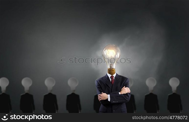 Stand out. Businessman in suit with light bulb instead of head