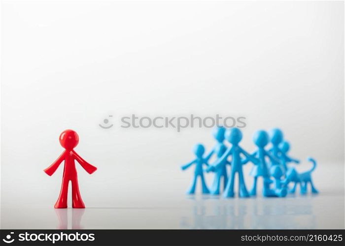 Stand out from the crowd ,different leadership concept. The red plastic firure stands out from the crowd
