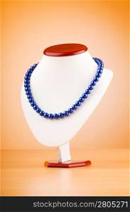 Stand with necklace in fashion concept
