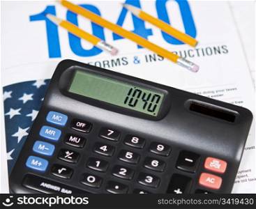 Standard IRS tax forms with pencils and calculator