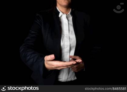 Standing Businesswoman Holding Important Messages Above One Hand.. Businesswoman Holding Important Message On Hand. Woman In Suit Showing New Crutial Idea Above One Palm. Executive Presenting Updated Critical Information.