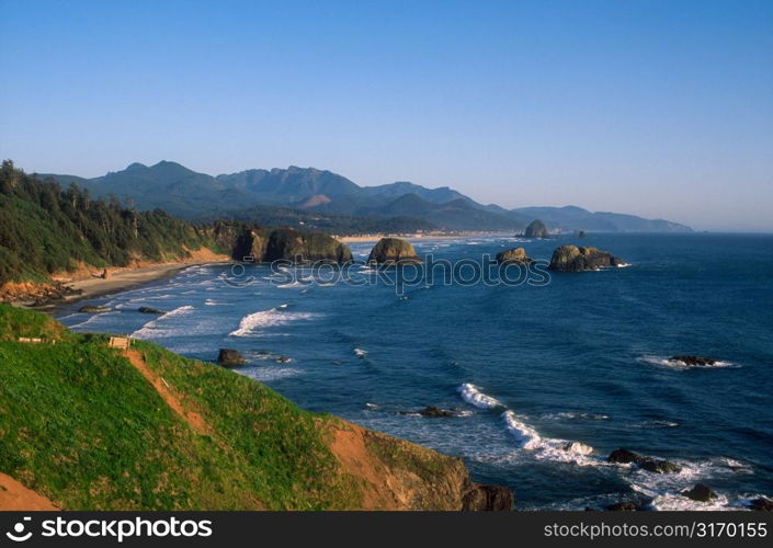 Standing On Rocky Cliffs Overlooking The Ocean