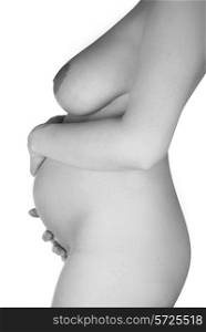 Standing pregnant woman in profile isolated on white. Black and white photo.