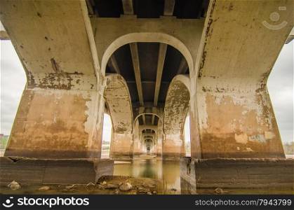 standing under old bridge over the river
