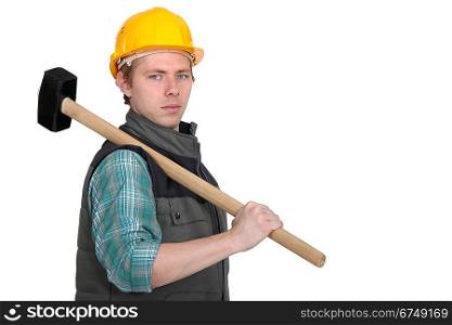 Standoffish tradesman holding a mallet
