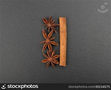 Star anis and cinnamon stick on shale