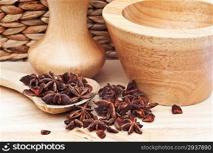 Star anise in rustic kitchen scene with wooden utensils
