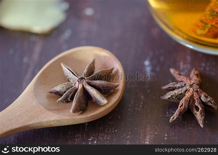 Star anise on brown wooden background, shallow focus