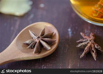 Star anise on brown wooden background, shallow focus