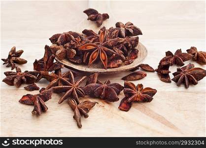 Star anise on wooden serving spoon with shallow depth of field