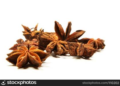 Star anise spice fruit and seeds on a white surface