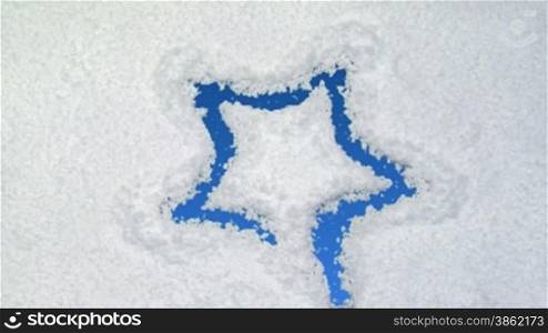 Star drawn on snow background with matte