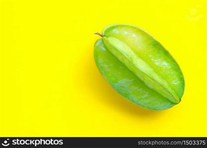 Star fruit on yellow background. Copy space