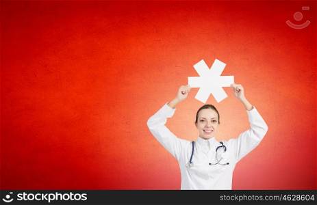 Star of life. Young female doctor holding medicine symbol in hands