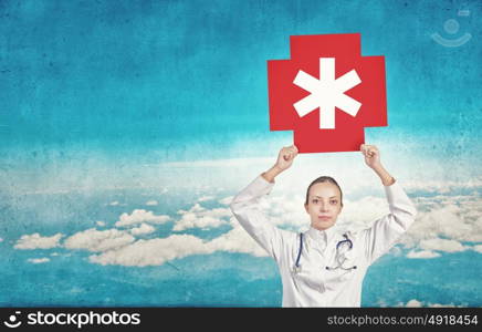 Star of life. Young female doctor holding medicine symbol in hands