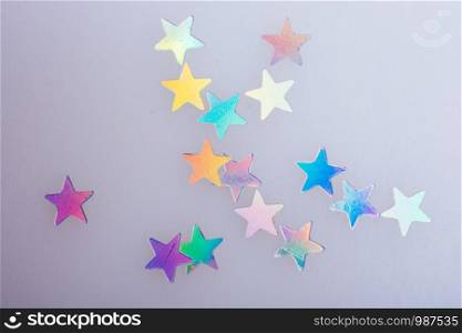 Star shaped bright paper on a blue fabric background