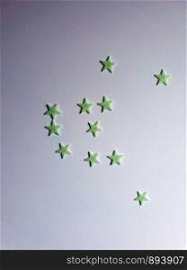 Star stickers plastered on the wall background texture, space for text colorful. Star stickers plastered on the wall background texture, space for text