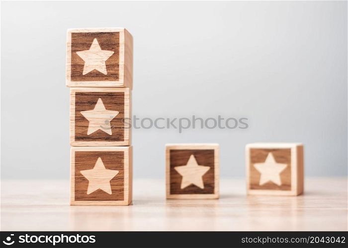 star symbol block on table background. Service rating, ranking, customer review, satisfaction, evaluation and feedback concept