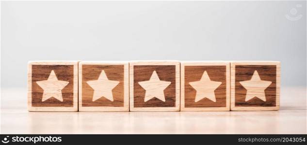 star symbol block on table background. Service rating, ranking, customer review, satisfaction, evaluation and feedback concept