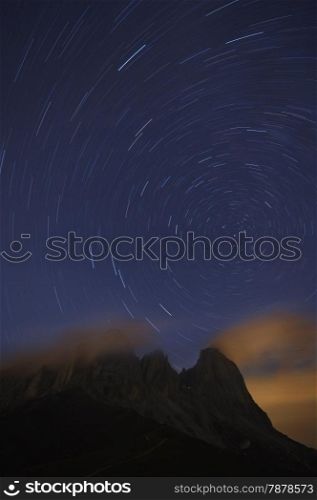Star tracks over Sassolungo mountain range. Dolomites mountains, Italy