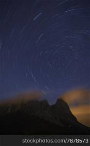 Star tracks over Sassolungo mountain range. Dolomites mountains, Italy