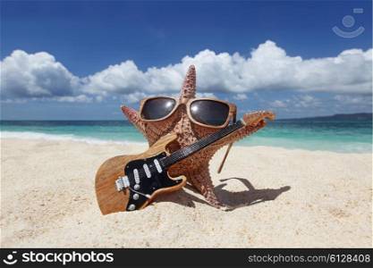 Starfish guitar player on beach. Starfish guitar player on sand of tropical beach at Philippines