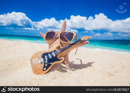 Starfish guitar player on beach. Starfish guitar player on sand of tropical beach at Philippines