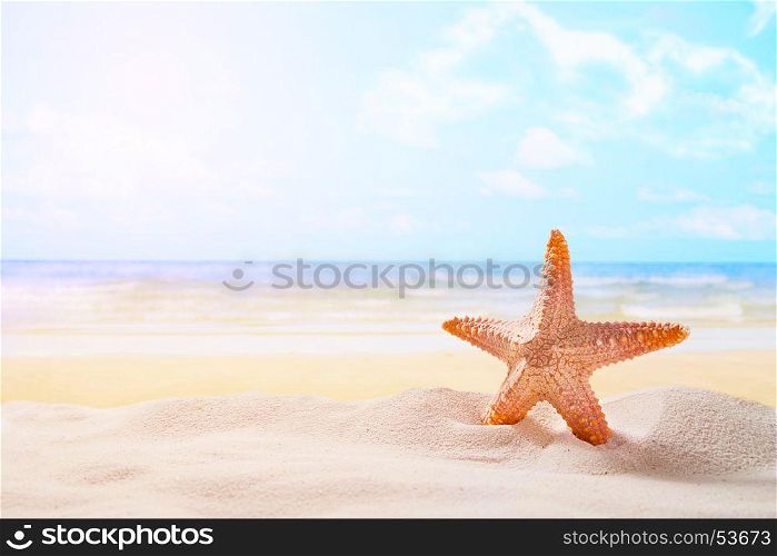 Starfish on summer sunny beach at ocean background. Travel, vacation concepts.