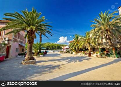 Stari grad on Hvar island palm waterfront, Dalmatia, Croatia