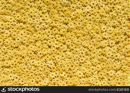 Stars shaped pasta - yellow abstract background